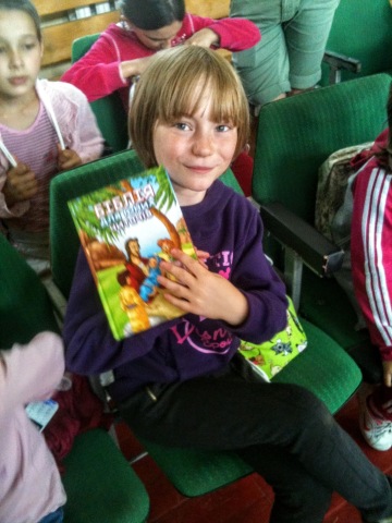 Younger camper Sofia shortly after receiving her new children's Bible.